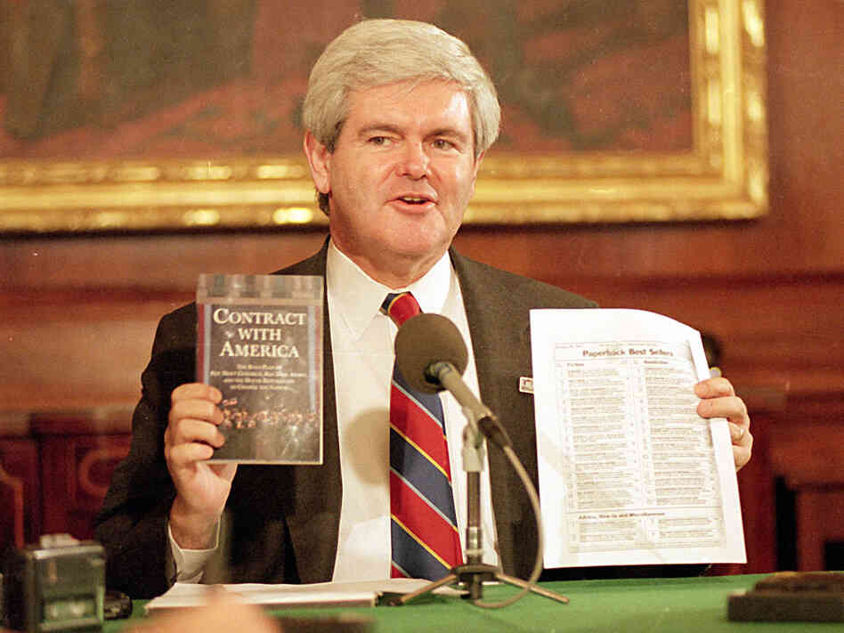 Then-House Speaker Newt Gingrich holds up his 'Contract With America'