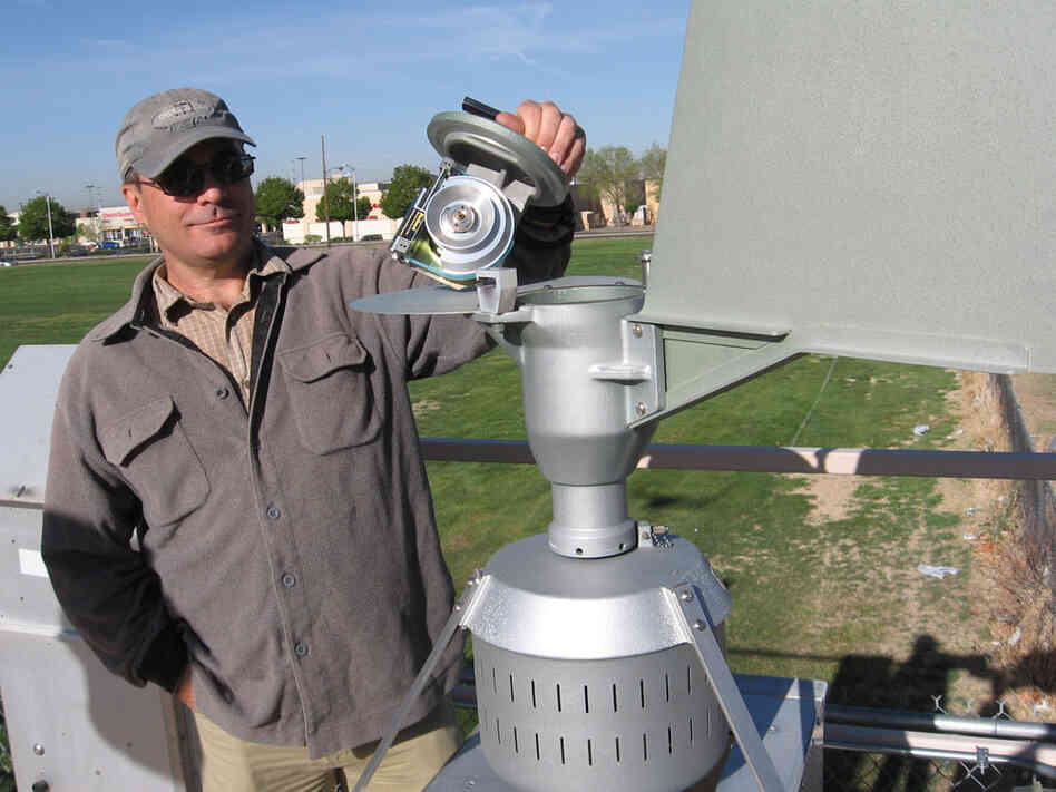 Dan Gates, with Albuquerque's Air Quality Division, measures pollen in the air.