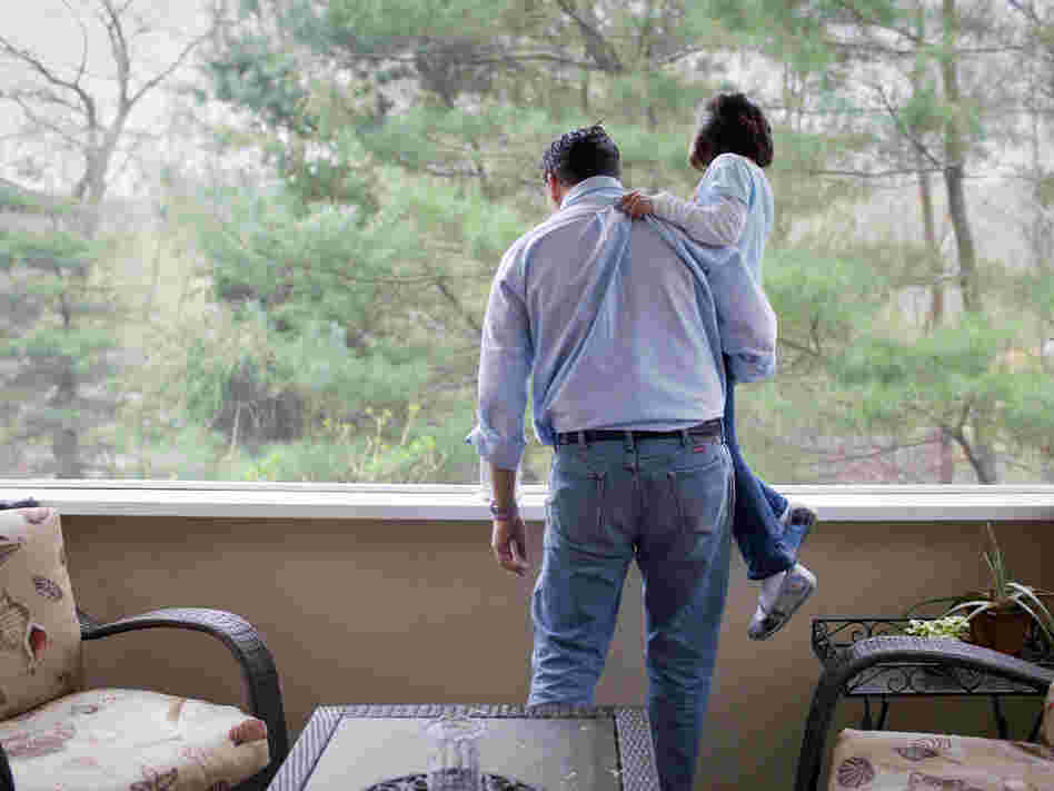 Isabelle and her father look out a window