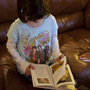 Isabelle reads a book with her mom