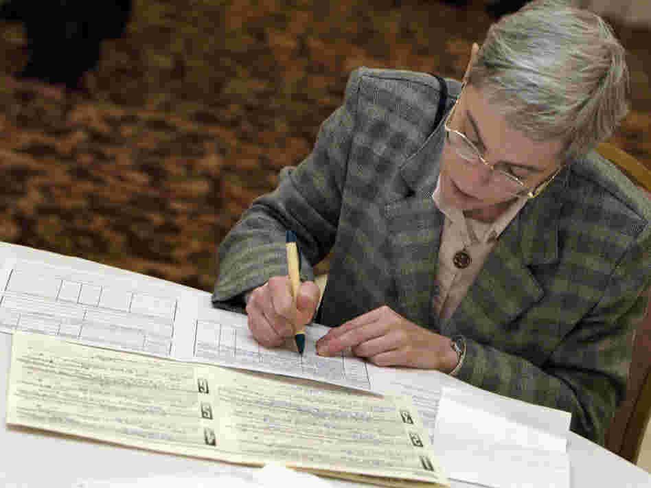 A job-seeker fills out an application at a senior job fair in Palatine, Ill., in 2003.