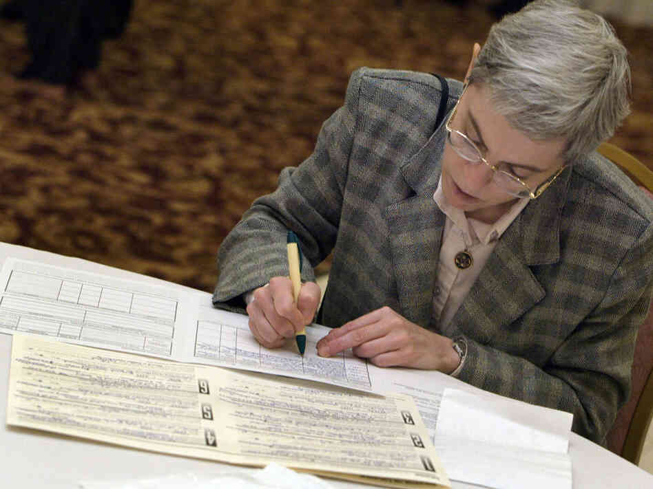 A job-seeker fills out an application at a senior job fair in Palatine, Ill., in 2003.