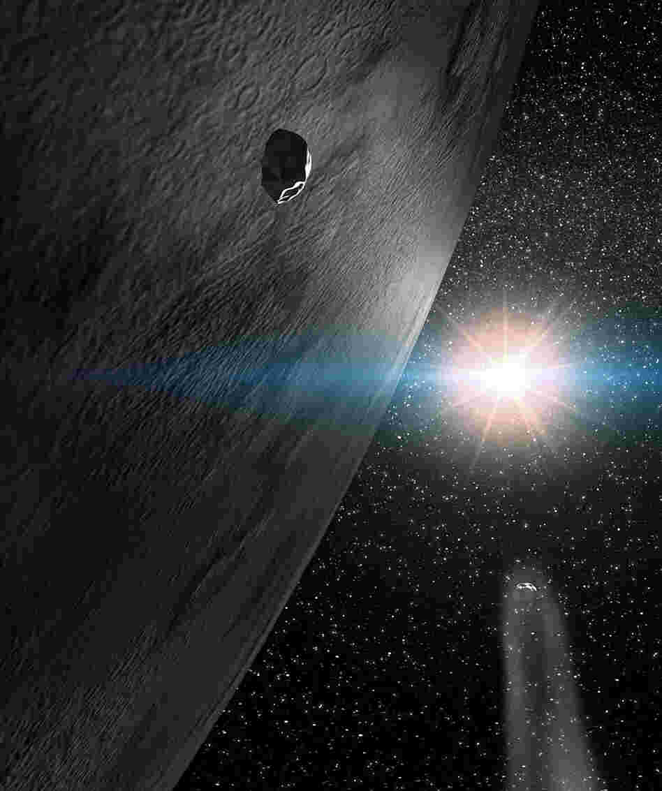The asteroid 24 Themis flanked by two small fragments
