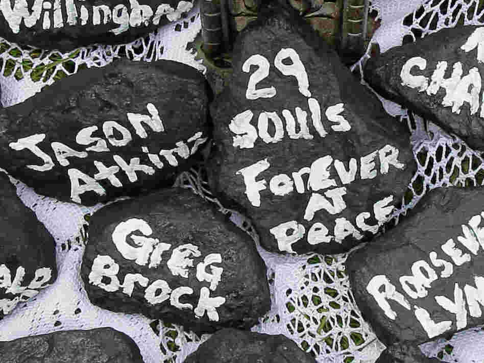 Chunks of coal bear the names of the miners who died April 5.