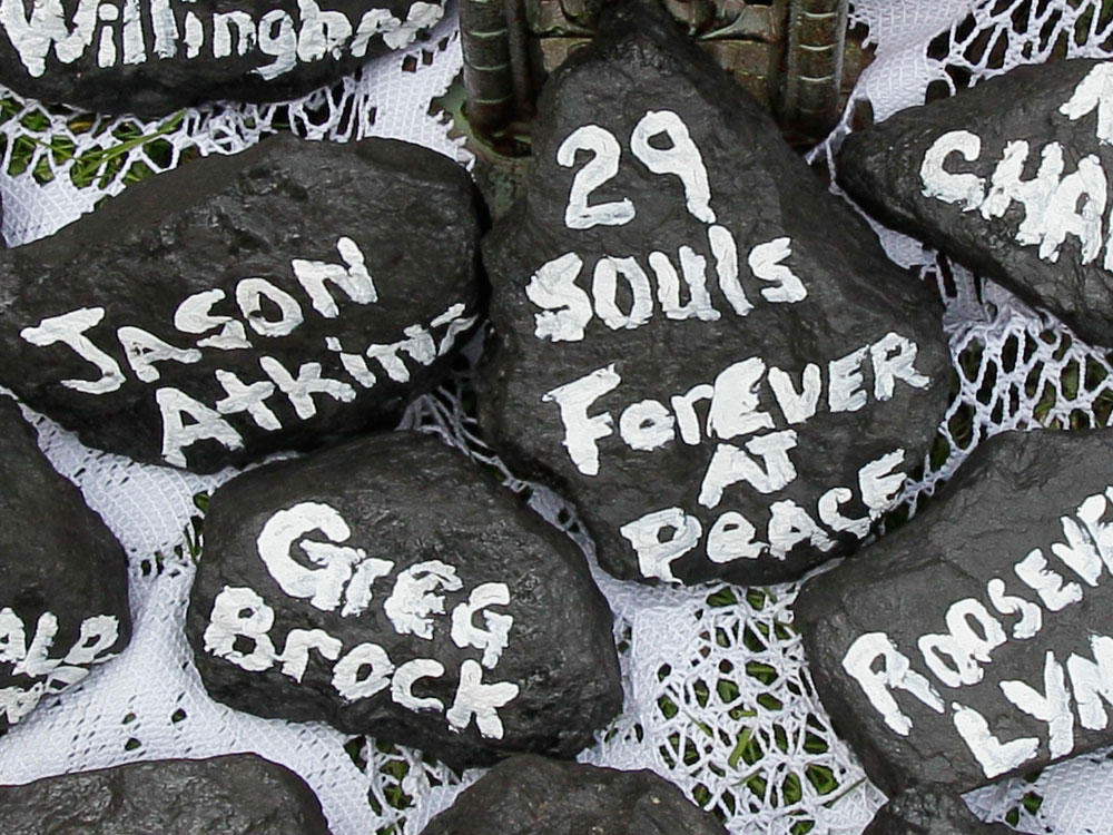 Chunks of coal bear the names of the miners who died April 5.
