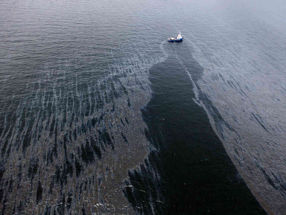 A boat with an oil boom tries to contain the spill in the Gulf. A boat with an oil boom tries to contain the spill in the Gulf.