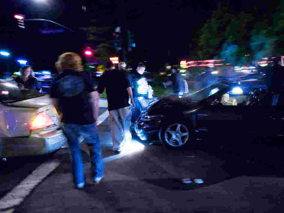 Teens get out of their cars after a crash