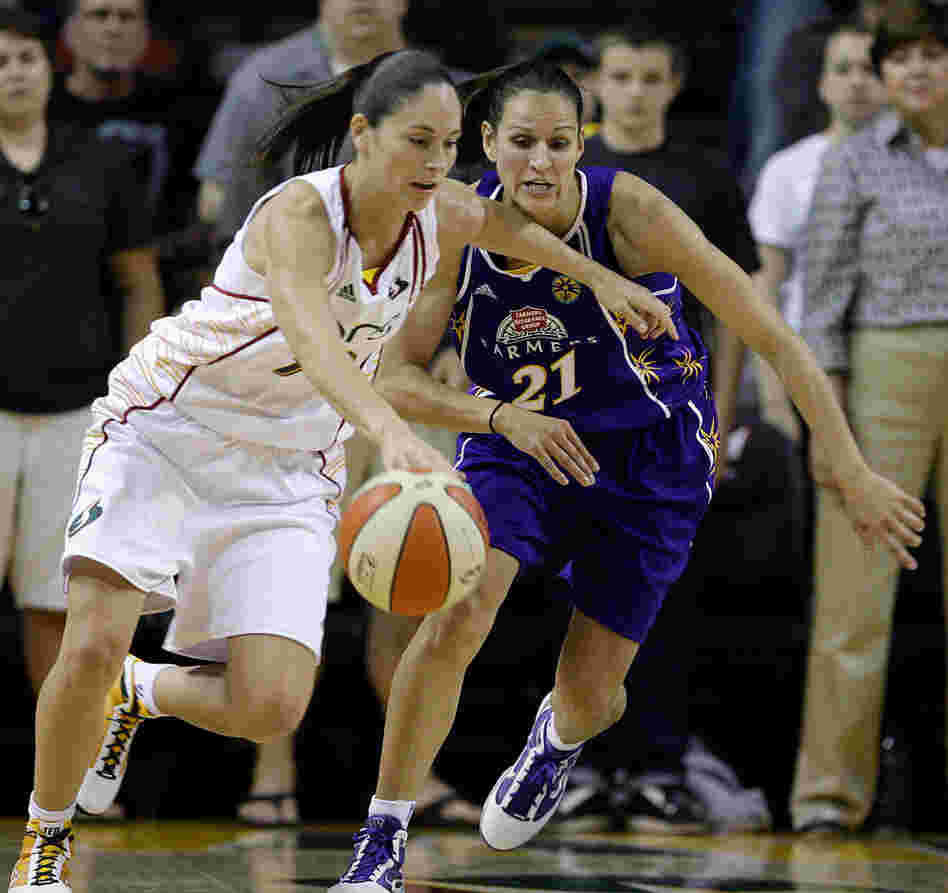 Seattle's Sue Bird tries to drive past Los Angeles Sparks' Ticha Penicheiro