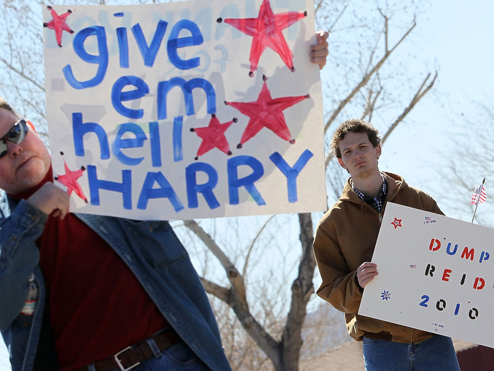 Supporters and opponents of U.S. Senate Majority Leader Harry Reid jockey for position outside an April campaign event in Fernley, Nev. With a slew of combative primary races, the summer is shaping up to be a hot one on the political scene.