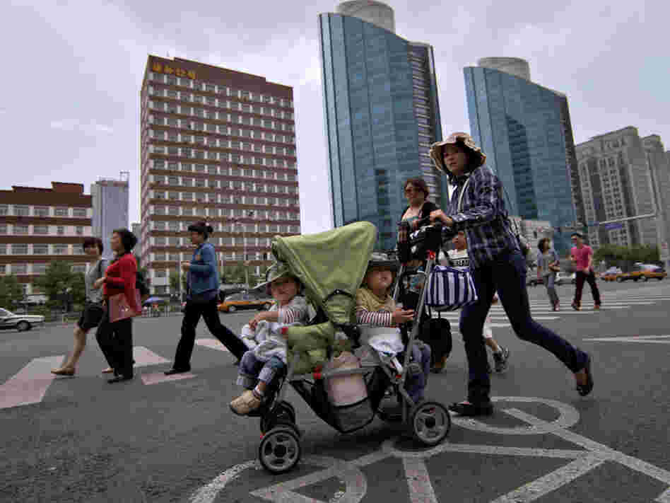 A woman pushes a stroller in Beijing.