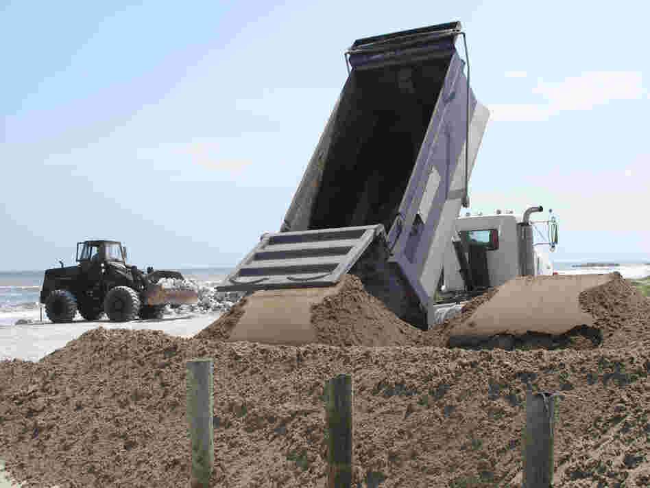 National guard troops move sand and boulders at Port Fourchon.