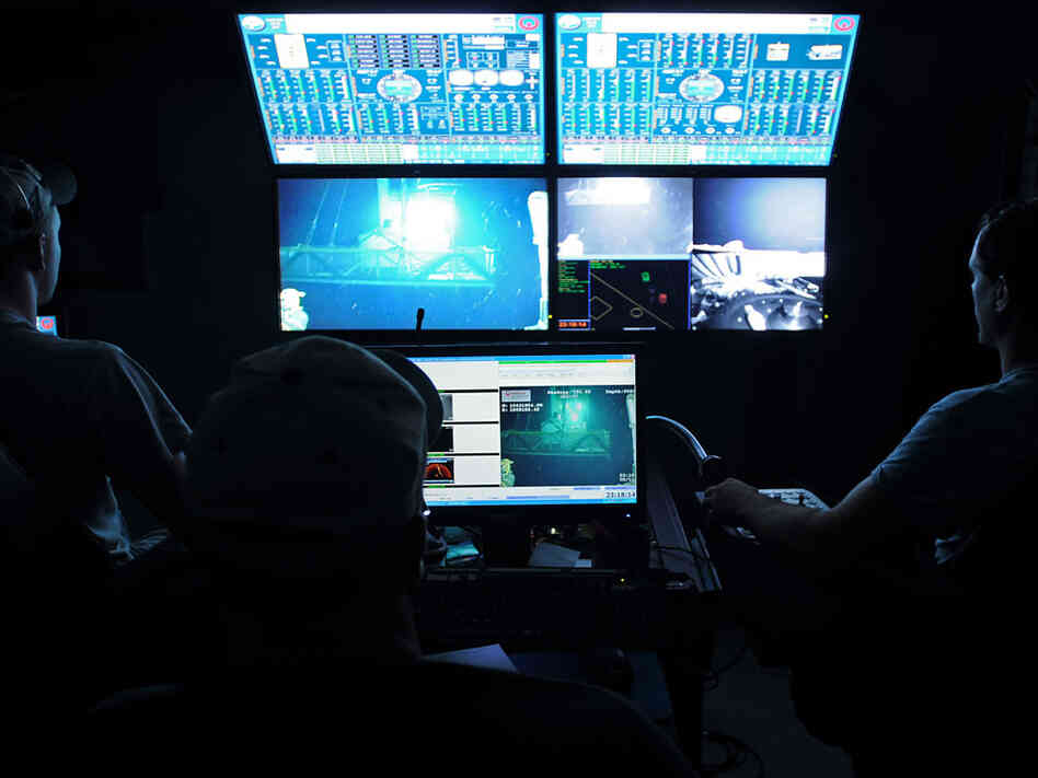 Ryan Gressett and Todd Schilla pilot a remotely operated vehicle into the Gulf.