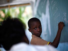 Lochard Samael works on a math problem with his teacher. Lochard Samael works on a math problem with his teacher.