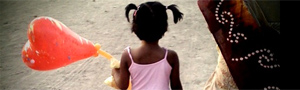 A girl walks with a baloon in India, near the Grand Trunk Road. Credit: Kainaz Amaria for NPR