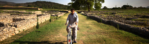 Man rides bike through ruins of an ancient city, near the Grand Trunk Road. Credit: John Poole/NPR