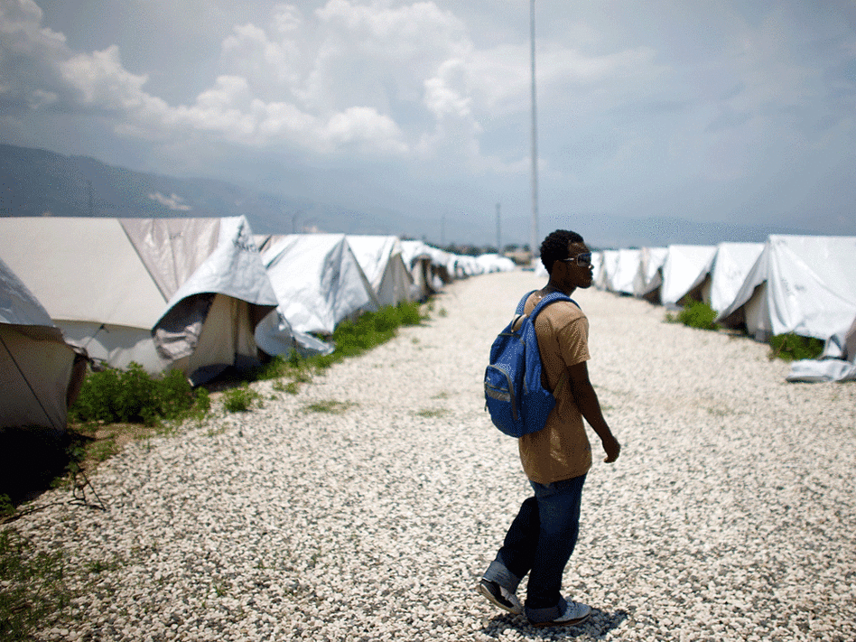 Guard Louis Juste Giteau walks through the unused camp built by the Haitian government.