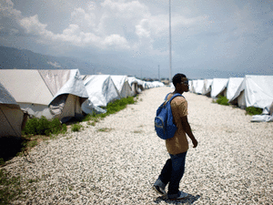 Guard Louis Juste Giteau walks through the unused camp built by the Haitian government. Guard Louis Juste Giteau walks through the unused camp built by the Haitian government.