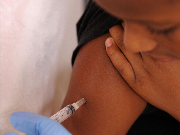 A nurse gives a young boy a vaccination. (AFP/Getty Images)