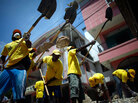Haitians help remove rubble in the coastal city of Leogane Haitians help remove rubble in the coastal city of Leogane
