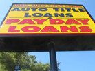 A sign for an auto title loans store is shown in Madison, Wis. A sign for an auto title loans store is shown in Madison, Wis.