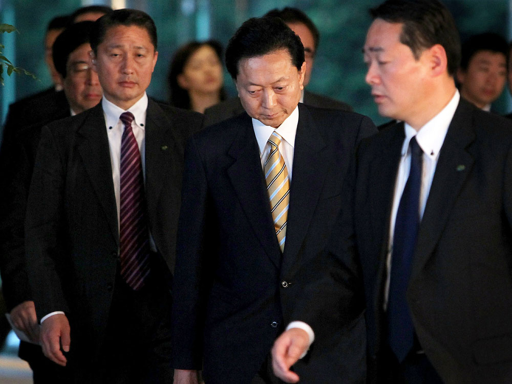 Japanese Prime Minister Yukio Hatoyama (center) leaves his official residence in Tokyo.