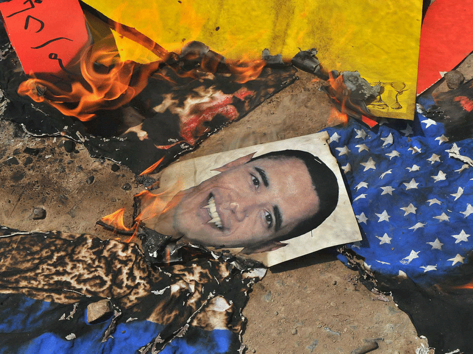 Pakistani protesters burn an image of President Obama on May 15.