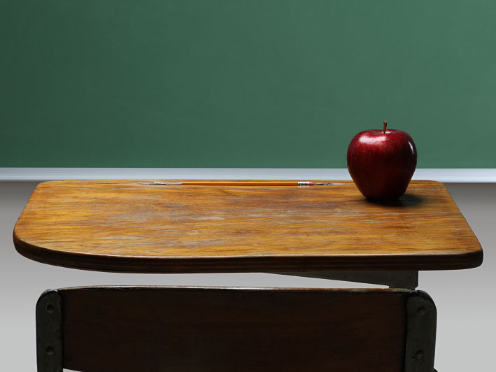 An apple placed on a student's desk