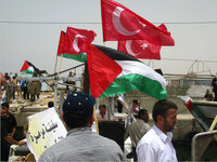 Turkish flags fly from Palestinian boats in the Gaza port as Gazans show solidarity with the Turkish activists who were killed Monday trying to break Israel's blockade.