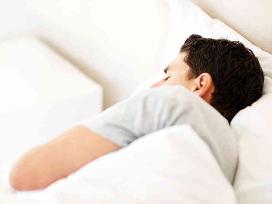 A man sleeping in a bed