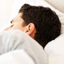 A man sleeping in a bed A man sleeping in a bed