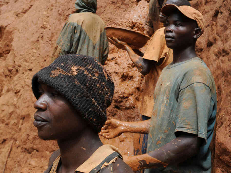 Gold miners on a muddy cliff in northeastern Congo. Gold miners on a muddy cliff in northeastern Congo.