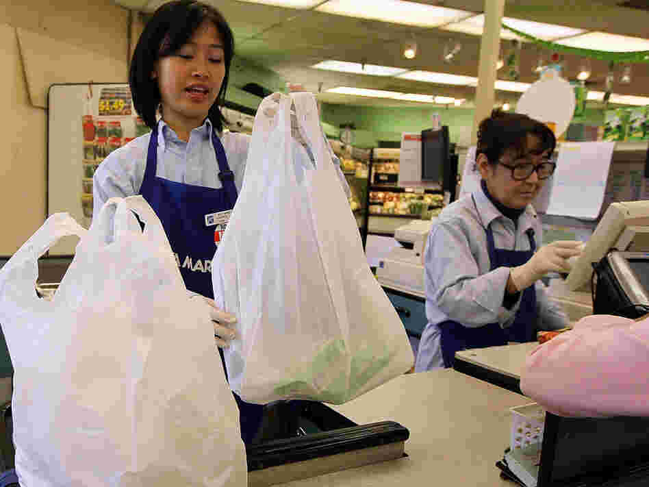 A cashier bags groceries last week in San Francisco.