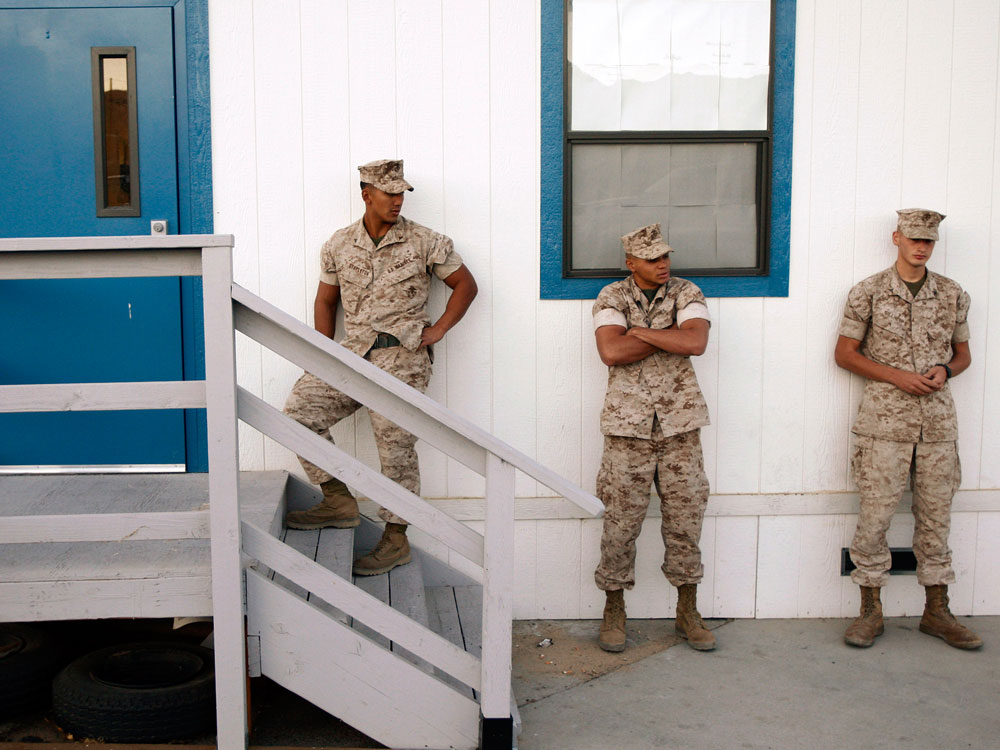 Three U.S. Marines waiting outside a building to take psychological tests