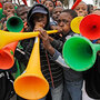 South African boys blow their vuvuzelas as they wait to attend the training session of the Cameroon 