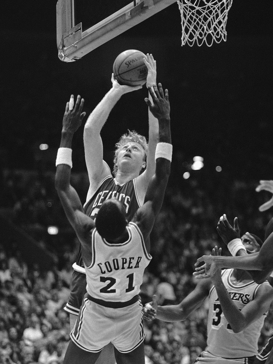 Celtics forward Larry Bird stretches over Lakers guard Michael Cooper in the 1984 series. Celtics forward Larry Bird stretches over Lakers guard Michael Cooper in the 1984 series.