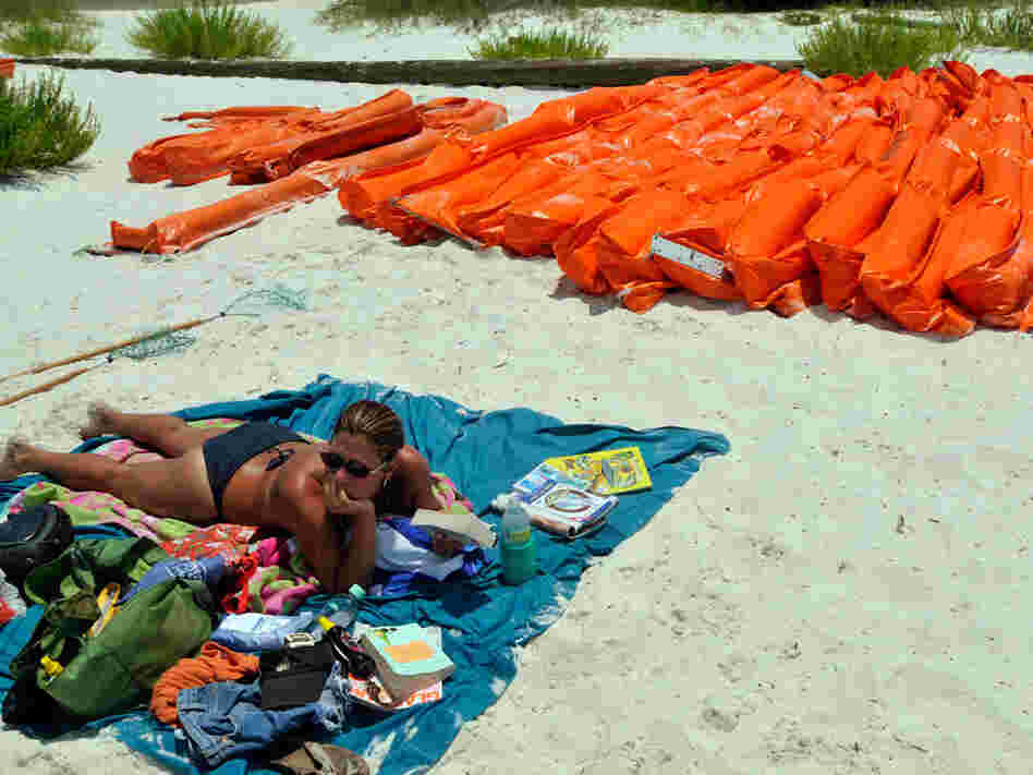 Kelly Ray of Gulf Breeze, Fla., reads while at Pensacola Beach