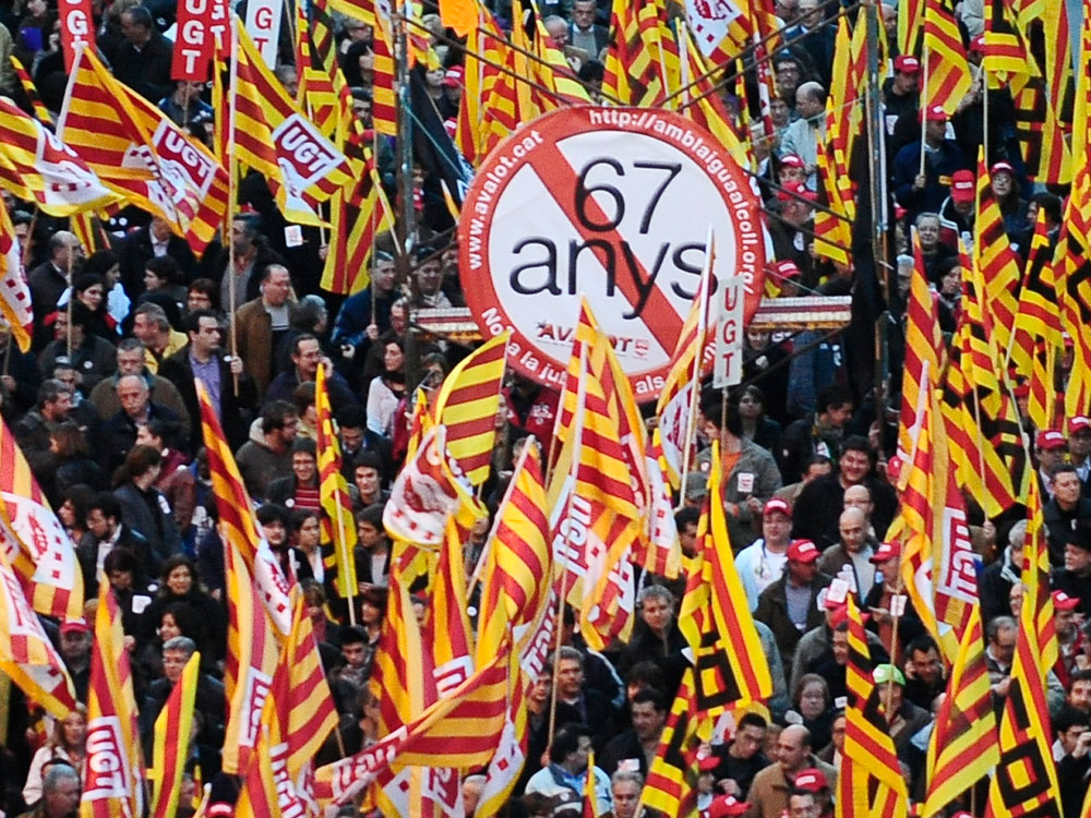 People protest against government plans to raise the retirement age in Barcelona, Spain.