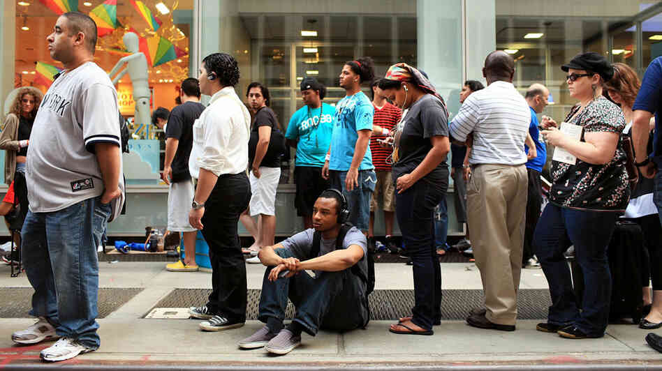 Customers wait in line for the new iPhone 4 at the Apple Store on Fifth Avenue in New York City. Customers wait in line for the new iPhone 4 at the Apple Store on Fifth Avenue in New York City.