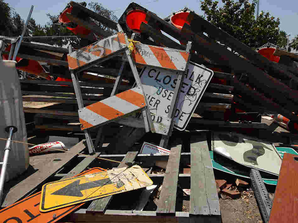 Road and construction signs lay in a pile in Maywood, Calif.