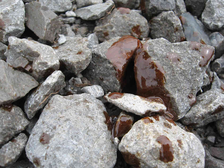 Oil stains the rocks along a beach in Port Fourchon, La.