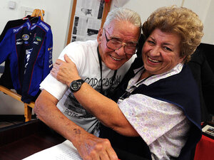 Co-worker Maria Ruiz hugs Chester Reed