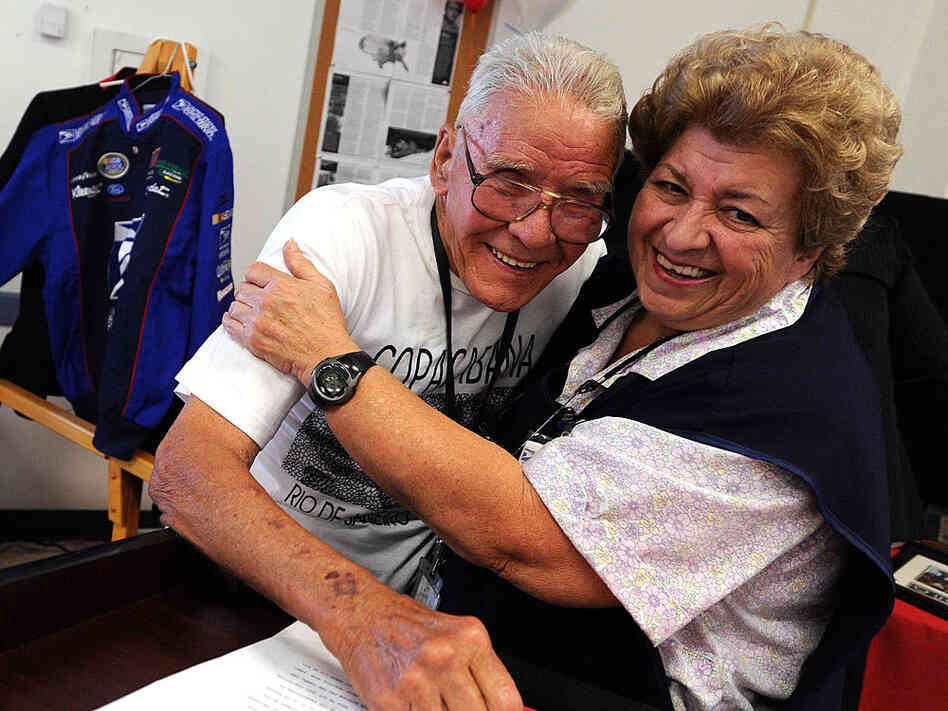 Co-worker Maria Ruiz hugs Chester Reed