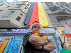 Ibrahim Bassal, Beirut-born shopkeeper, stands near the German flag displayed over his shop Ibrahim Bassal, Beirut-born shopkeeper, stands near the German flag displayed over his shop