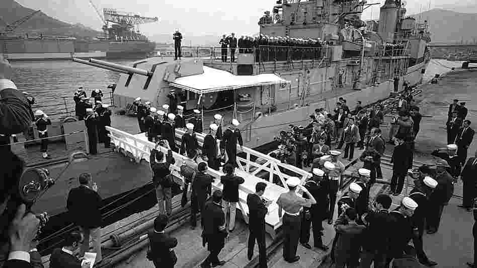 The body of aviation electronics technician Richard Edson Sweeney is brought ashore