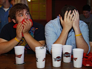 Cleveland fans react after watching free agent NBA basketball star LeBron James announce he will play for the Miami Heat.