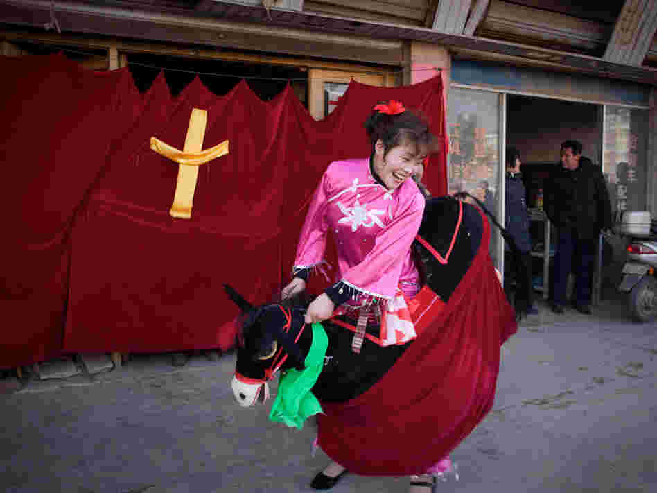 A woman from a government-sanctioned church performs in a Christan-themed street show