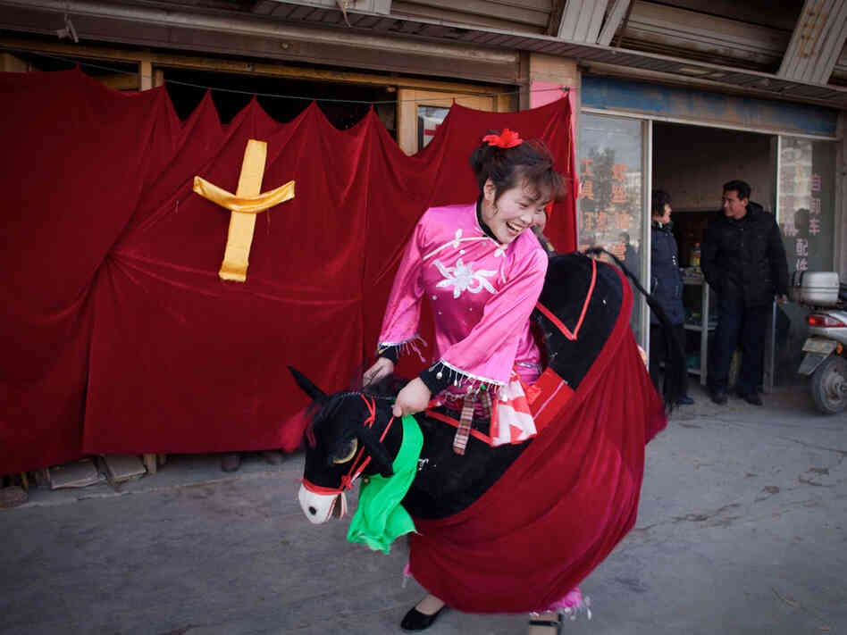 A woman from a government-sanctioned church performs in a Christan-themed street show