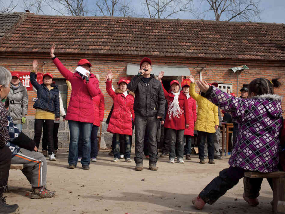 A group of traveling evangelical students sing religious songs in a rural village