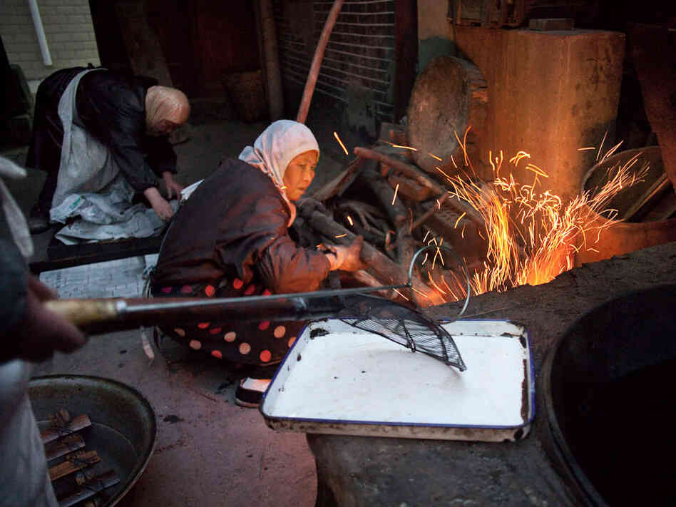 Women at the Wangjia mosque in central China work in the kitchen