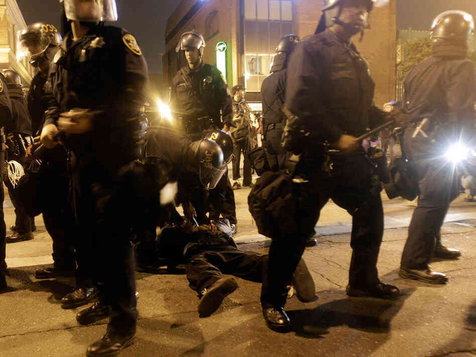 Oakland police officers hold a demonstrator, July 8, 2010.